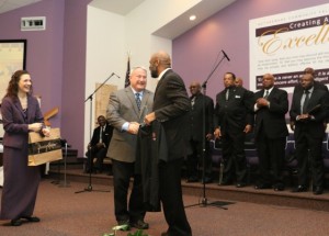 Kevin & Carol Hinman presenting Pastor Kirk Houston with an official LTI shirt.